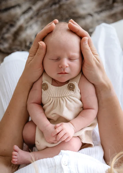 Newborn baby in mother's hands